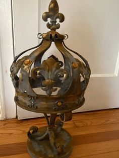 a metal object sitting on top of a hard wood floor next to a white door