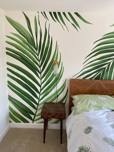 a bedroom with palm leaves painted on the wall