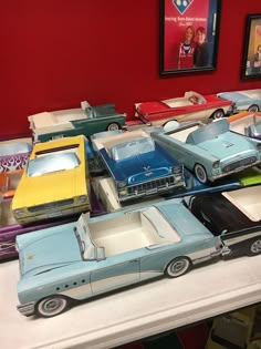 a bunch of toy cars sitting on top of a table