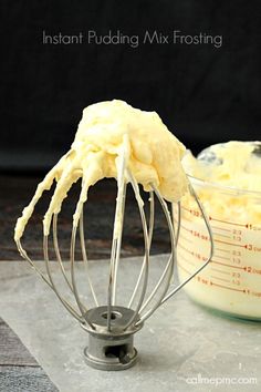 a whisk is being used to mix ingredients in a mixing bowl