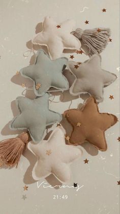 five star shaped cookies with tassels and stars on them, all in different colors