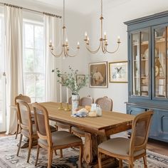 a dining room table with chairs and a china cabinet