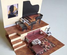 a miniature model of a living room with piano and couches on the top floor