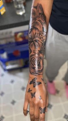 a person with a tattoo on their arm and hand is holding something in the air