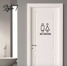 a white door with the words restroom on it