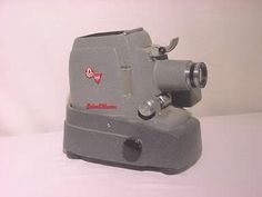 an old style grinder sitting on top of a white table