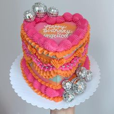 a birthday cake with pink and orange frosting