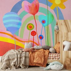 a child's bedroom with colorful flowers painted on the wall