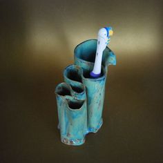 a toothbrush holder is shown in three different sizes and shapes, including one blue