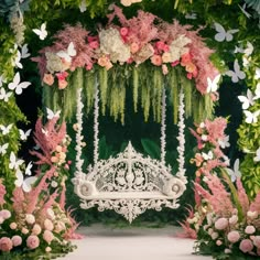 a white bench sitting under a lush green canopy covered in pink and white flowers, surrounded by greenery