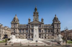 a large building with statues in front of it