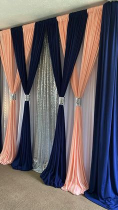 a room with blue and pink drapes on the wall