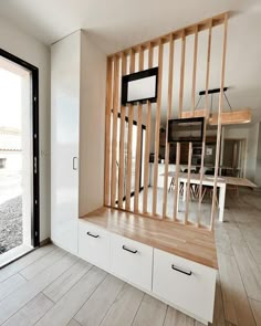 an empty room with wooden slats on the wall and sliding glass doors leading outside