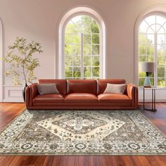 a living room filled with lots of furniture and large windows in the wall behind it