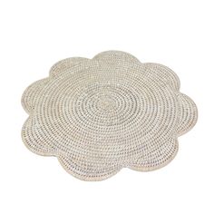 a white placemat with an intricate design on the top and bottom, made out of woven