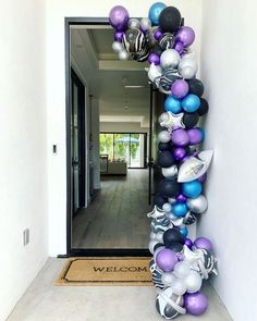 the entrance to a home decorated with balloons