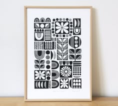 a black and white abstract art print on a shelf