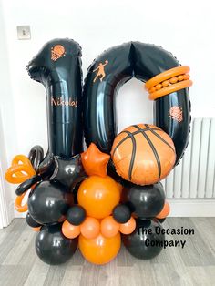 an arrangement of balloons and sports items in the shape of numbers