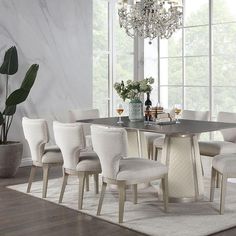 a dining room table with chairs and a chandelier