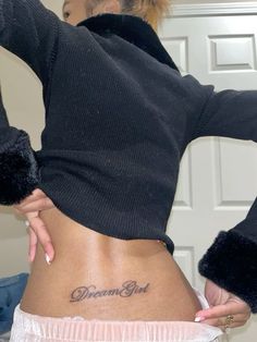 a woman with a tattoo on her lower back