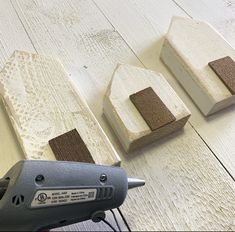 a person using a power drill to attach wood pieces on a table with white boards