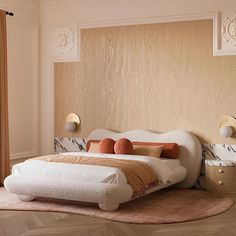 a large bed sitting on top of a wooden floor next to a window with curtains