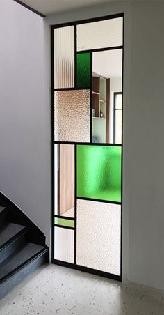 an open door with multiple colored glass panels on it