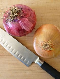 an onion and a knife on a cutting board