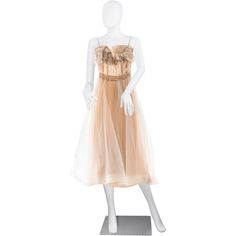 a mannequin with a dress on display in front of a white background,