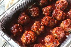 some meatballs are sitting in a metal pan