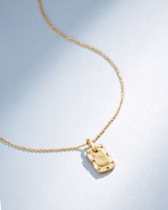 Inspired by classic design with a contemporary flair, our Golden Mini Dog Tag Diamond Pendant reflects Suzanne's signature style. This pendant features a sleek 18-karat gold dog tag, beautifully framed by a row of sparkling diamond baguettes. It's a versatile and elegant necklace, perfect for adding a touch of sophistication to your daily attire. Details 18k yellow gold, rose gold or white gold 0.13 carats of baguette white diamonds Measures 18" inches in length, adjustable at 16" inches Lobster Luxury Gold Dog Tag Necklace, Gold Rectangular Pendant With Baguette Diamonds, Luxury Everyday Necklace With Rectangular Pendant, Elegant White Gold Dog Tag Necklace, Elegant Everyday Dog Tag Necklaces, Elegant Everyday Dog Tag Jewelry, Elegant Everyday Dog Tag Necklace, Luxury Rectangular Pendant Necklace For Everyday, Elegant Jewelry With Box Chain Dog Tag