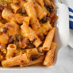 a casserole dish filled with pasta and meat