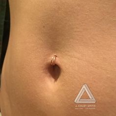 a close up of a person's stomach with a nose ring on top of it