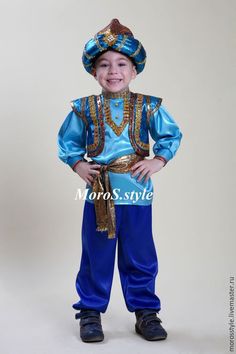 a young boy dressed in blue and gold is posing for the camera with his hands on his hips