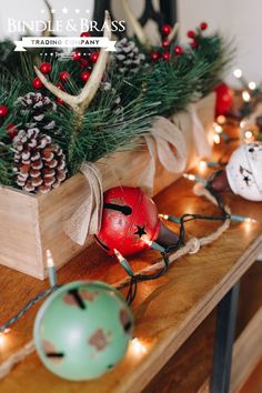 christmas decorations on a table with pine cones and ornaments in the center, including balls