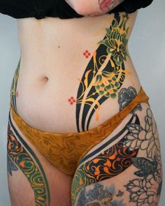 a woman with tattoos on her stomach