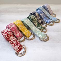 a row of key chains with different colors and designs on them, sitting on a white surface