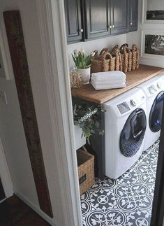 a washer and dryer sitting on top of a counter in a laundry room