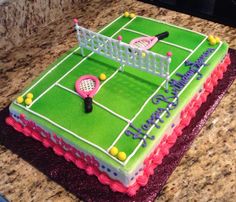 a birthday cake that is shaped like a tennis court