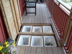 four white baskets sitting on top of a wooden porch