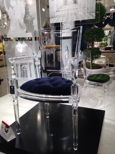 an acrylic chair is on display in a store with other furniture and decor