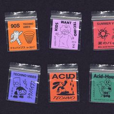 four different types of stickers in plastic bags on a black surface, with the words acid vibes and acid holo written across them