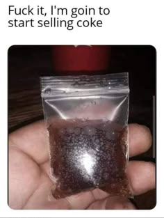 a hand holding a bag of brown liquid