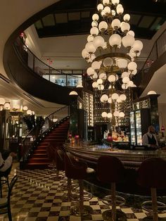 a chandelier hanging from the ceiling in a restaurant with checkered flooring