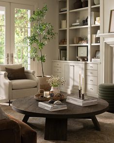 a living room filled with furniture and a tree in the middle of it's center table