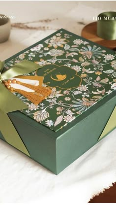 a green box with a bow on top of it