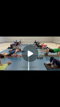 a group of people doing exercises on mats in a gym