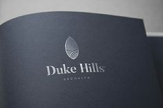 the duke hills brochure is open to show its company's brand identity