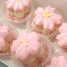 pink cupcakes with white frosting and yellow flowers