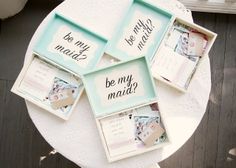 four frames with different sayings on them sitting on a table next to each other